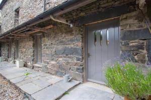 un edificio de piedra con una puerta a un lado en The Old Dairy en Ambleside