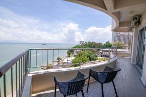 a balcony with two chairs and a view of the ocean at Rainbow paradise @ Tanjung Bungah in Tanjung Bungah