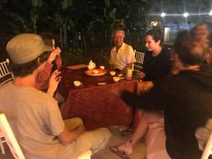 a group of people sitting around a table at Bee lucky homestay in Cat Ba +153 photos