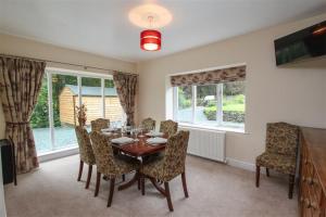 a dining room with a table and chairs at Elterwater Lodge in Little Langdale