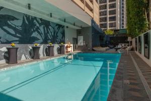 a large swimming pool in a building at Kimpton Hotel Palomar Los Angeles Beverly Hills, an IHG Hotel in Los Angeles