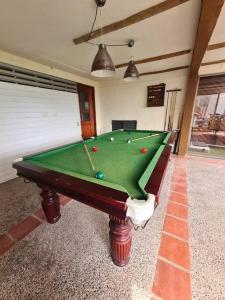 a pool table with balls on it in a room at Gran casa en Totoralillo con vista al mar y más! in Coquimbo