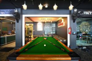 a pool table in a room with a bar at KOKO Party Hostel in Ao Nang Beach