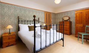 a bedroom with a bed and a dresser at Greystones in Bowness-on-Windermere