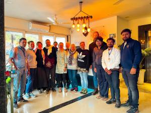 a group of people posing for a picture in a room at The कस्तूरी in Maihar