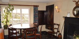 a dining room with a table and chairs and a window at Yew Tree Farm in Coniston