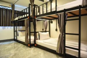 a room with two bunk beds in a room at KOKO Party Hostel 18-40 in Ao Nang Beach