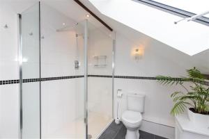 a bathroom with a toilet and a glass shower at The Gallery in Grasmere +4 photos