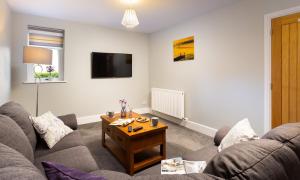 a living room with a couch and a coffee table at Glebe Holme in Windermere