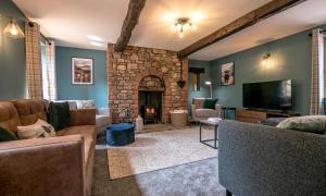 a living room with a couch and a fireplace at Waltons Close in Stainton