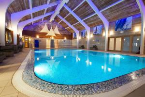 a large swimming pool in a hotel lobby at Waltons Close in Stainton