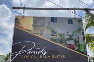 a sign for a tropical palm villas in front of a house at Amazing 2 bedroom apt 1 warm cosy comfortable in Belmont