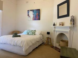 a bedroom with a bed with a teddy bear on it at Central CBD House in Wagga Wagga