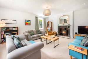 a living room with two couches and a tv at Hilltop At Hawkshead Hill in Ambleside