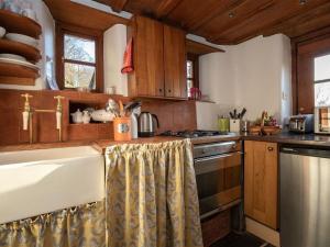 a kitchen with a sink and a stove at Dovecot Cottage in Ambleside