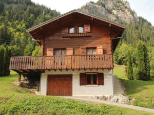 a wooden house with a balcony on a hill at Chalet Châtel, 5 pièces, 8 personnes - FR-1-200-212 in Châtel