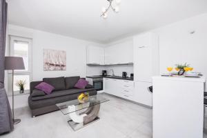 a living room with a couch and a table at Fantasy Pool Villa in Novalja