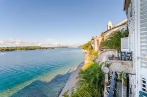 a view of the ocean from a balcony of a building at Rooms Sonja P in Rab +19 photos