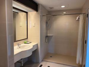 a bathroom with a sink and a shower at Legend Inn Taiping in Taiping