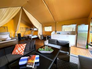 a living room with a couch and a tent at BIG4 Mackay Blacks Beach Holiday Park in Mackay