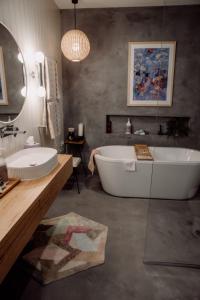 a large bathroom with a tub and a sink at Tocumwal Chocolate School in Tocumwal