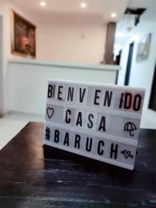 un signo que dice benjamin iccolo casa barcelona en una mesa en Casa Baruch, en Bogotá