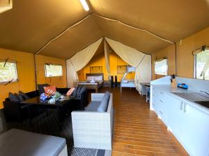 a living room with a tent with couches and tables at BIG4 Mackay Blacks Beach Holiday Park in Mackay