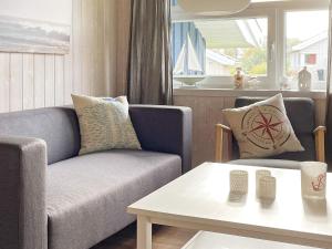 a living room with a couch and a table at 6 person holiday home in Otterndorf in Otterndorf