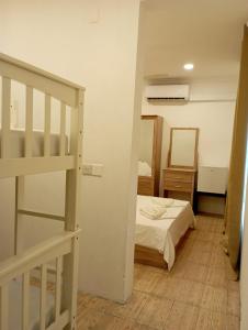 Un pequeño dormitorio con una cama y una escalera en Paradisola en Fodhdhoo