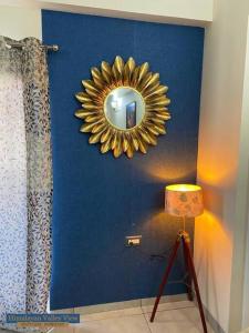 a mirror on a blue wall in a room at Himalayan Valley View - A boutique homestay in Dehradun