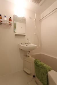a bathroom with a sink and a bath tub at Building A101 / Vacation STAY 1277 in Tokyo