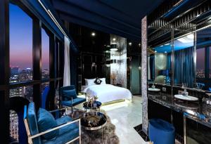 a hotel room with a bed and a view of a city at Hotel The Designers DDP in Seoul