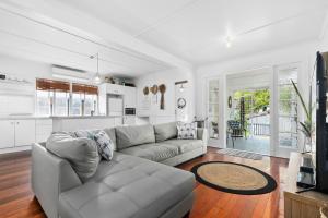 a living room with a couch and a kitchen at The Shack in Woorim