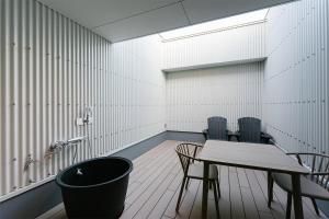 a meeting room with a table and chairs in it at Hotel Mazarium in Morioka