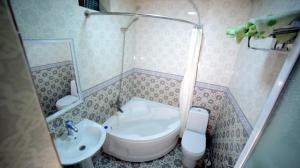 a small bathroom with a sink and a toilet at Guest House Dilorom in Khiva