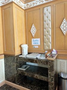 a kitchen with a counter with a coffee maker on it at โรงแรมกู๊ดเรสซิเดนซ์ - Good Residence in Nong Khae
