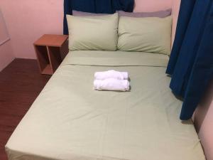 a white towel sitting on top of a bed at 2 storey Camella Homes in Pagadian City in Pagadian