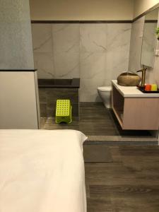 a bathroom with a tub and a toilet and a sink at YY Elleys Home in Jiaoxi