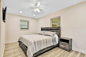 a bedroom with a bed and a ceiling fan at Uncork and Unwind You are on Lake Time in Sebring