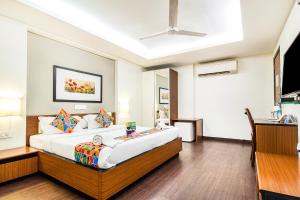a bedroom with a large bed in a room at FabHotel Prime Avenue in Indore