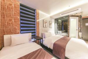 Postel nebo postele na pokoji v ubytování MG Hotel