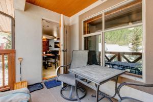 a table and chairs in a room with a balcony at Powderhorn Lodge 504 Aspen View Villa in Brighton