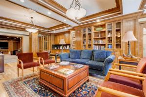 a living room with a blue couch and chairs at Powderhorn Lodge 504 Aspen View Villa in Brighton