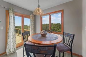 a dining room with a table and chairs and a balcony at Ss OBX SS111 in Southern Shores