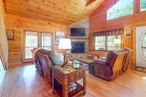 a living room with a fireplace in a log cabin at Bear Essentials in Sevierville