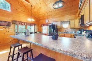 a large kitchen with a large counter in a cabin at Bear Essentials in Sevierville