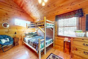 a bedroom with two bunk beds in a log cabin at Bear Essentials in Sevierville