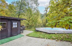 a backyard with a hot tub and a shed at Beautiful Home In Cornuda With Sauna, 1 Bedrooms And Outdoor Swimming Pool in Cornuda