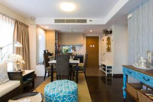 a living room with a kitchen and a dining room at Baan Sandao D201 in Hua Hin