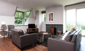 a living room with two couches and a fireplace at Harrison Stickle in Bowness-on-Windermere
